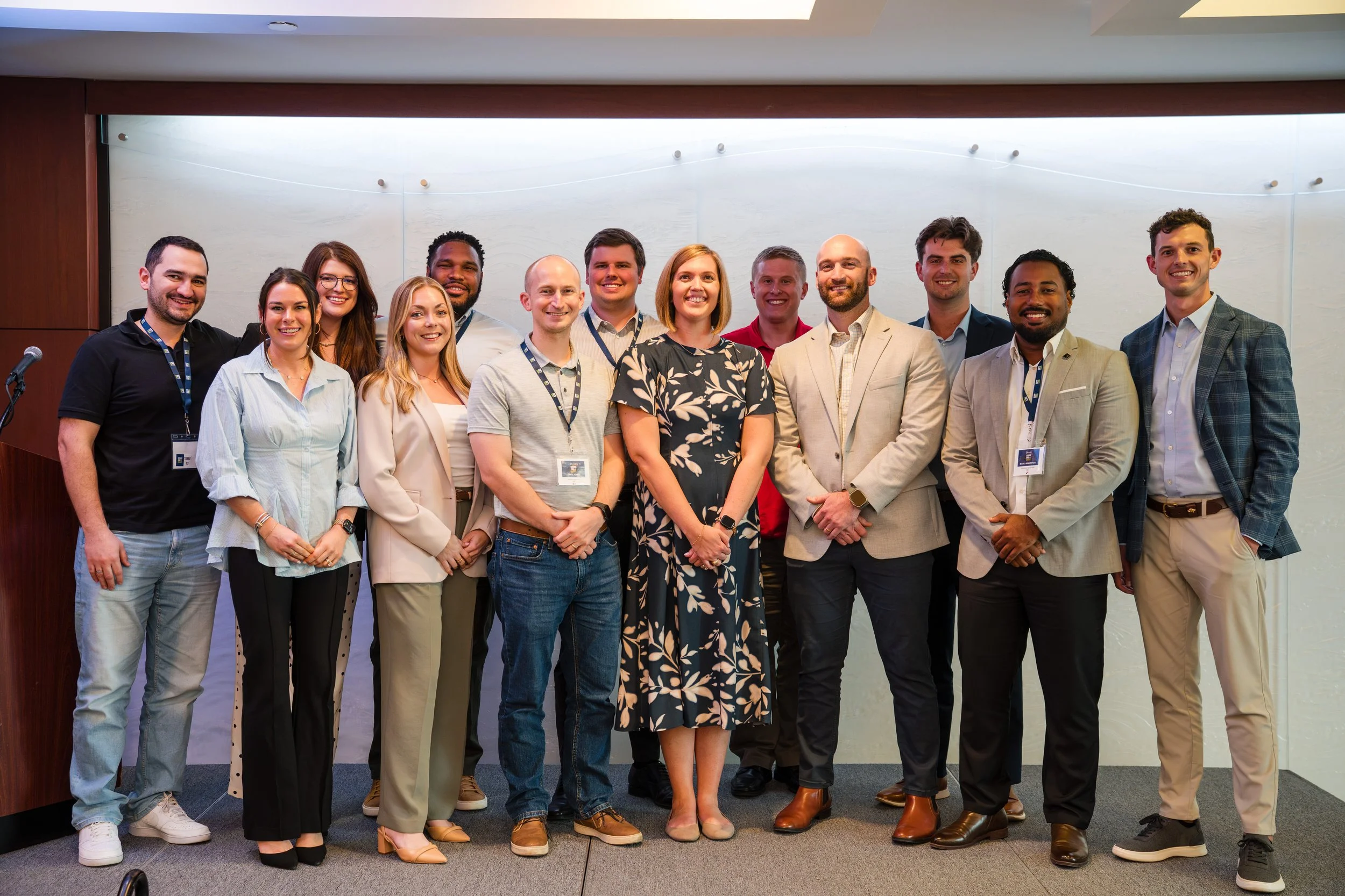 Corporate leadership team posing together during conference event