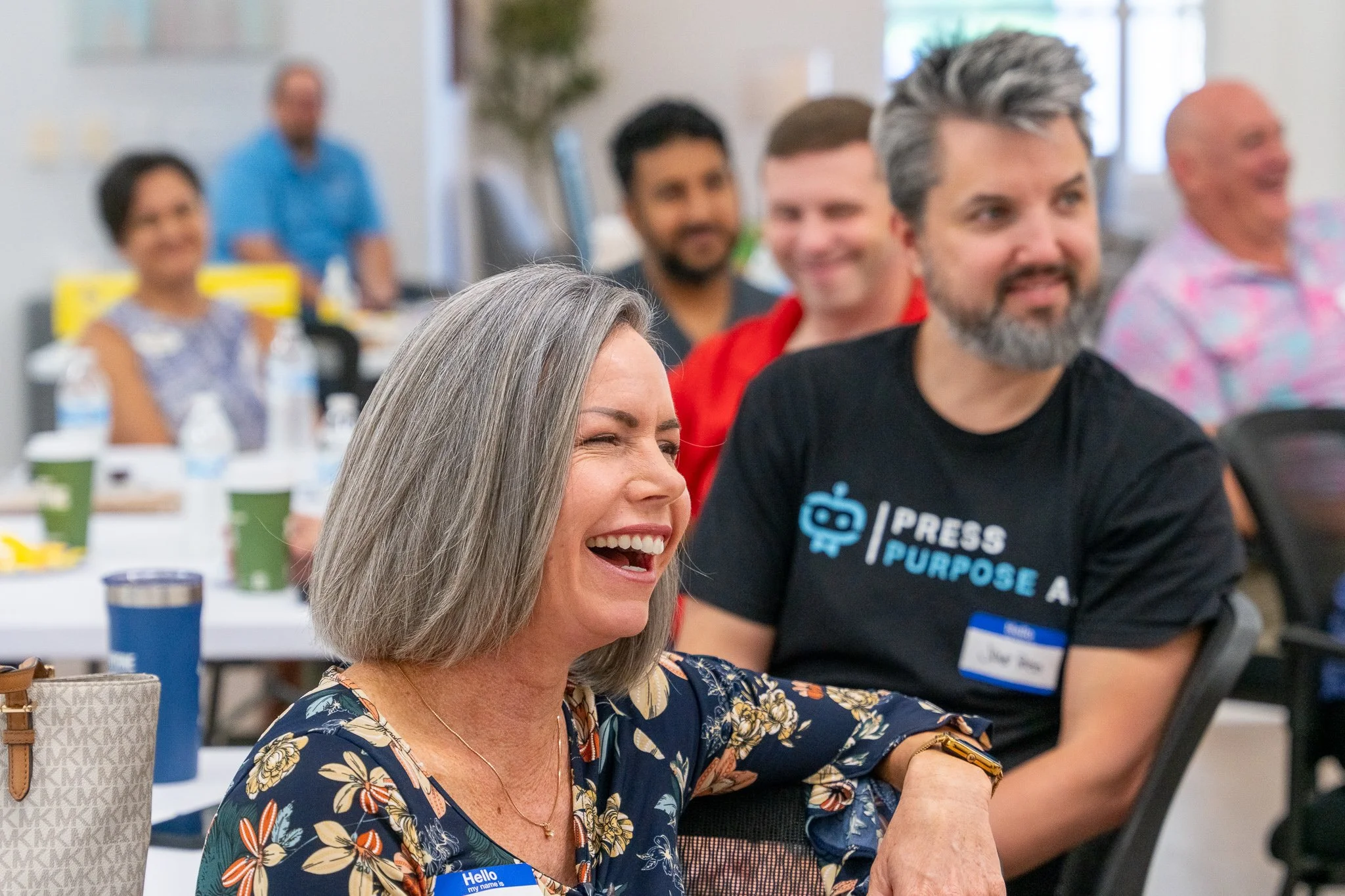 Conference attendee laughing during corporate seminar session