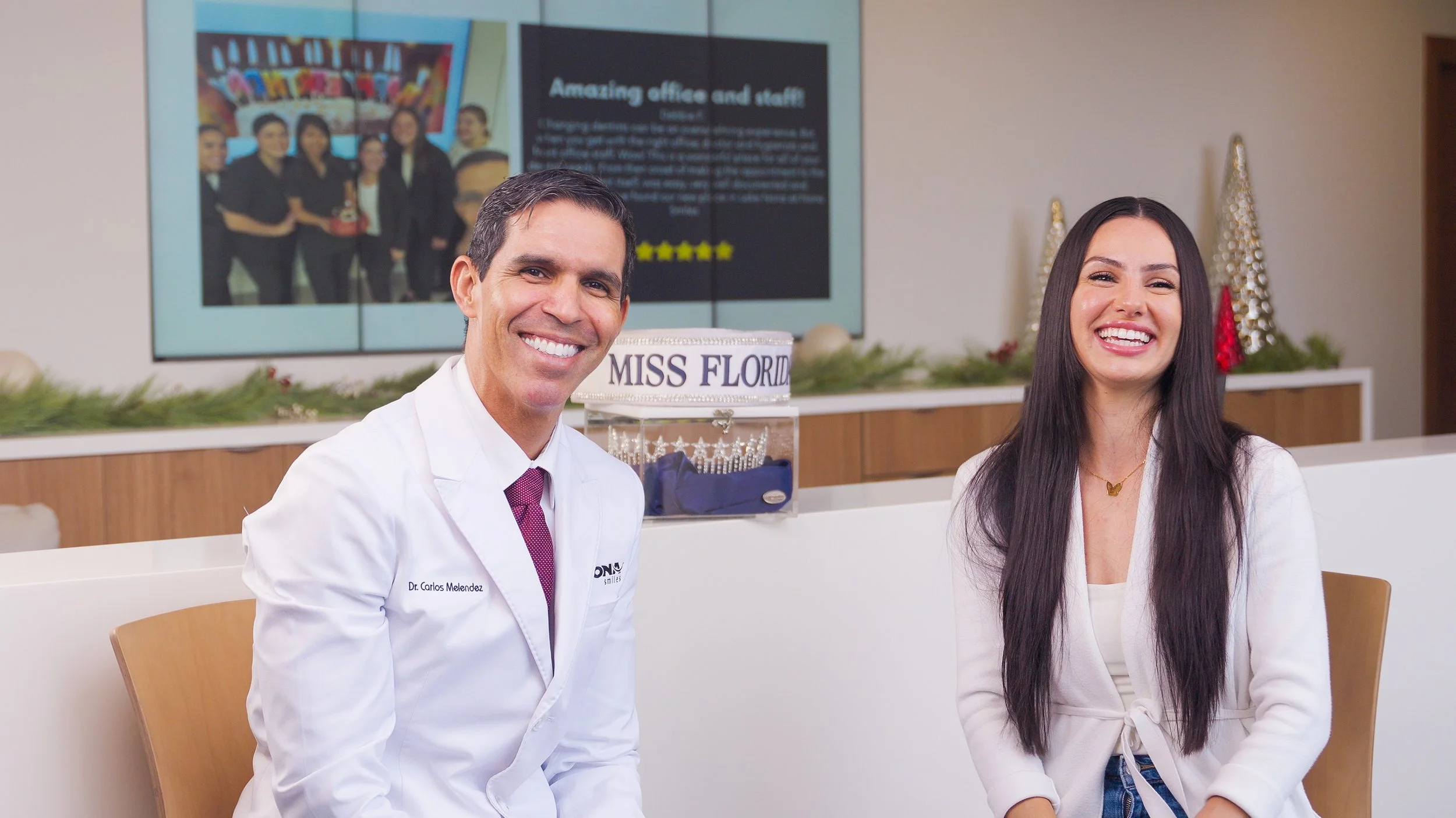 Two individuals posing in a gym, one holding a camera, capturing a workout session.