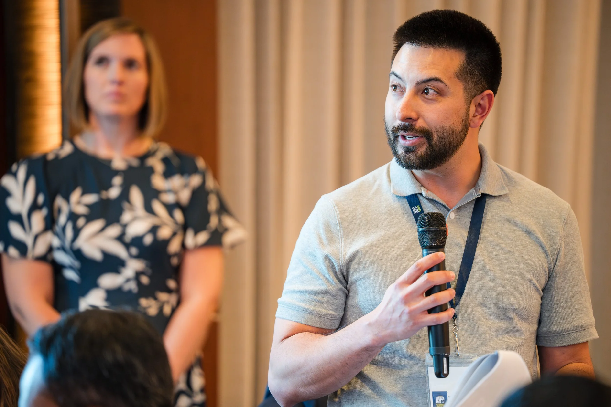 Conference attendee asking question with microphone