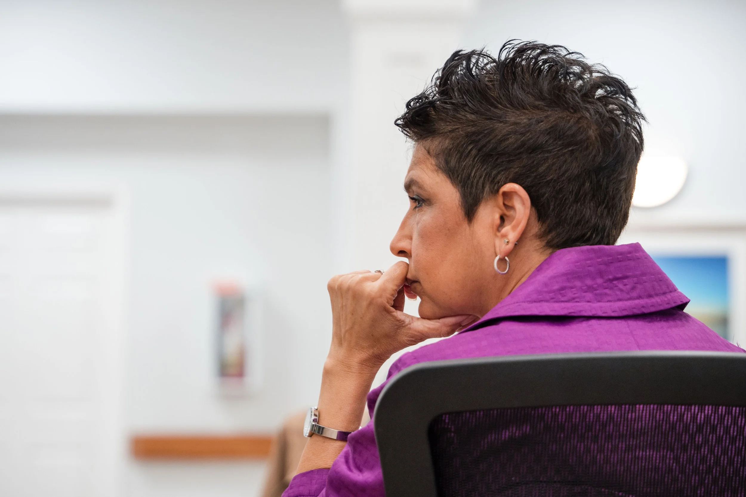 Conference attendee listening during keynote presentation