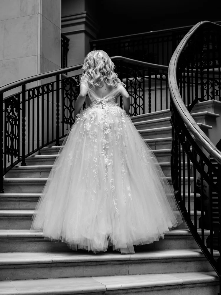 Wedding guests dancing under warm lights at evening reception — dancefloor photography by Oliver Holder