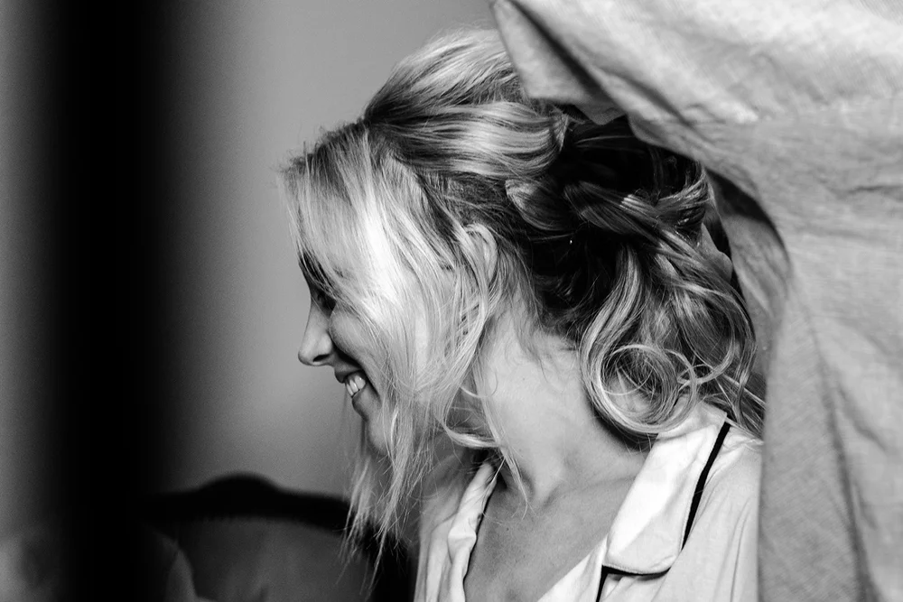Katie laughing with her bridesmaids on the morning of her Hurlingham Club wedding