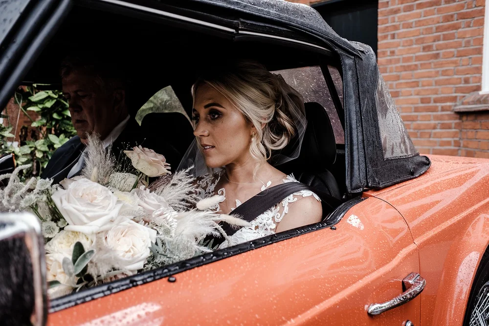 Katie arriving at The Hurlingham Club with her father in the open-top Triumph TR7