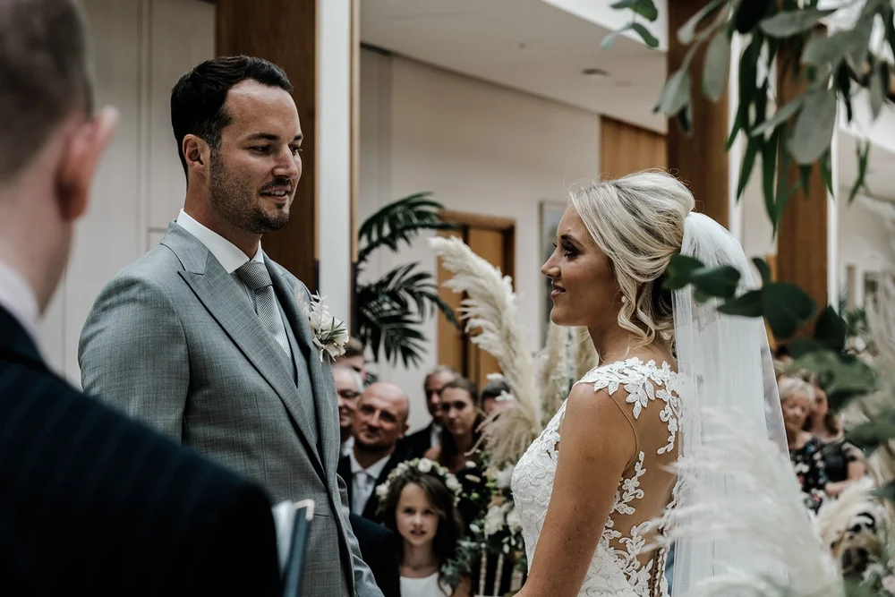 Guests watching the wedding ceremony in the Palm Court at The Hurlingham Club