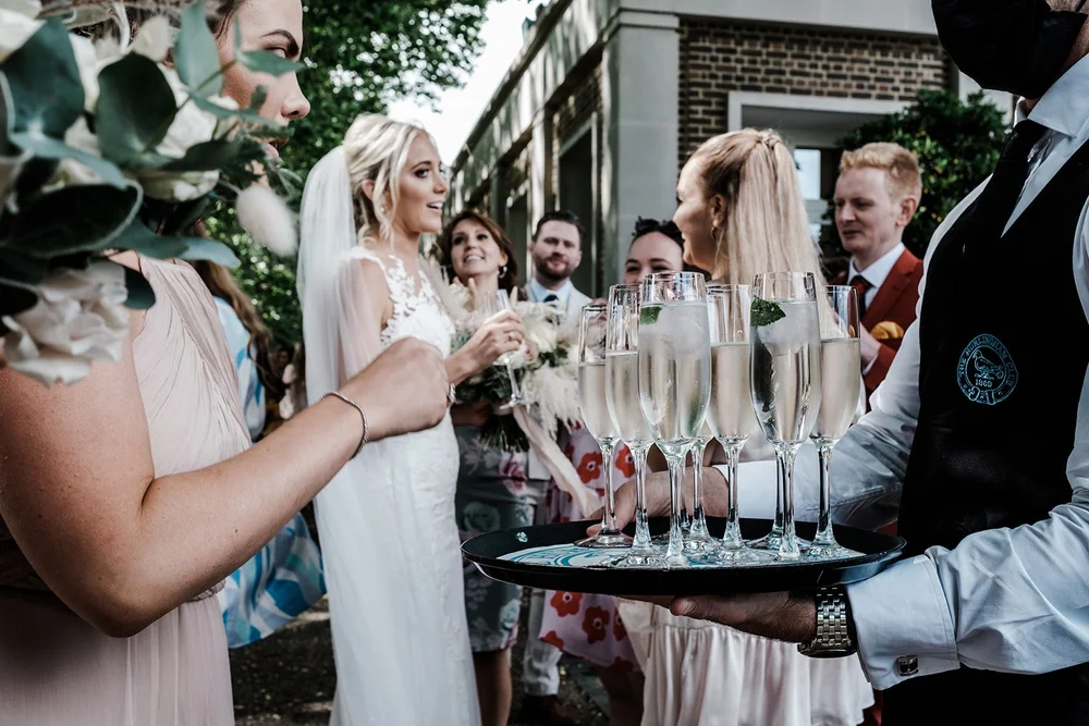 A tray of champagne being carried through the drinks reception at The Hurlingham Club