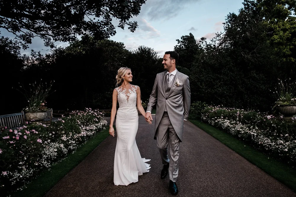 Mike and Katie on the garden path at The Hurlingham Club in the late afternoon