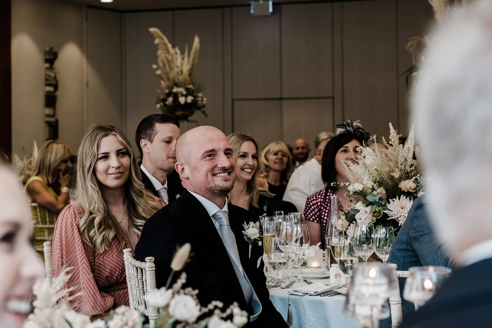 Guests reacting to the wedding speeches at The Hurlingham Club