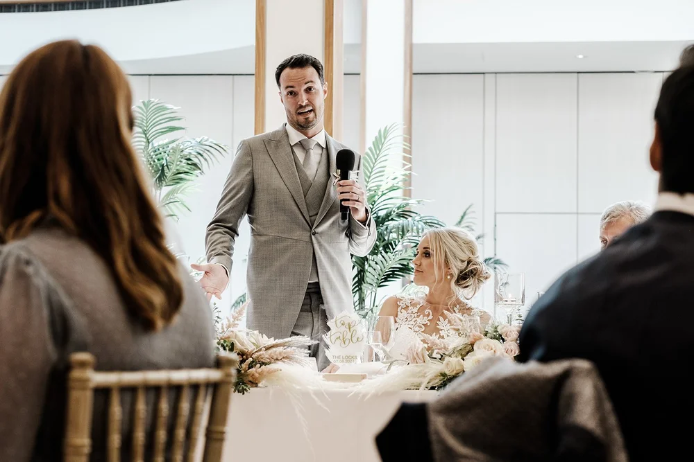 A guest laughing at the top table during the speeches