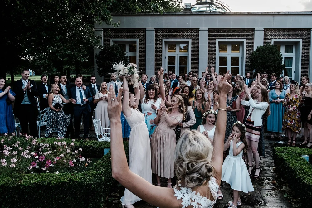 Guests applauding outside in the grounds at The Hurlingham Club