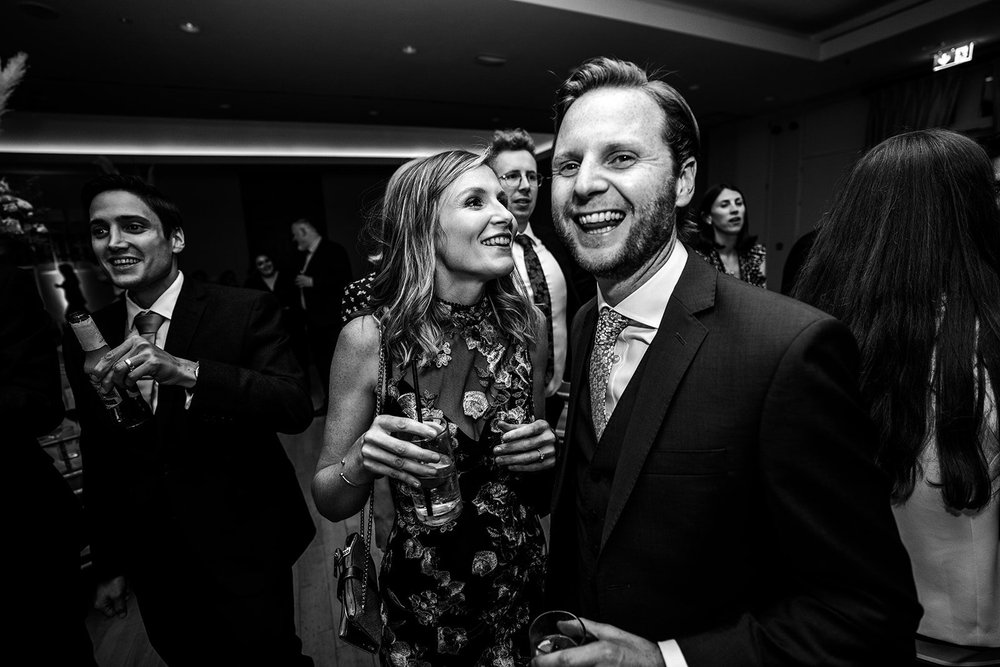 Black and white photograph of two guests late in the evening at the reception