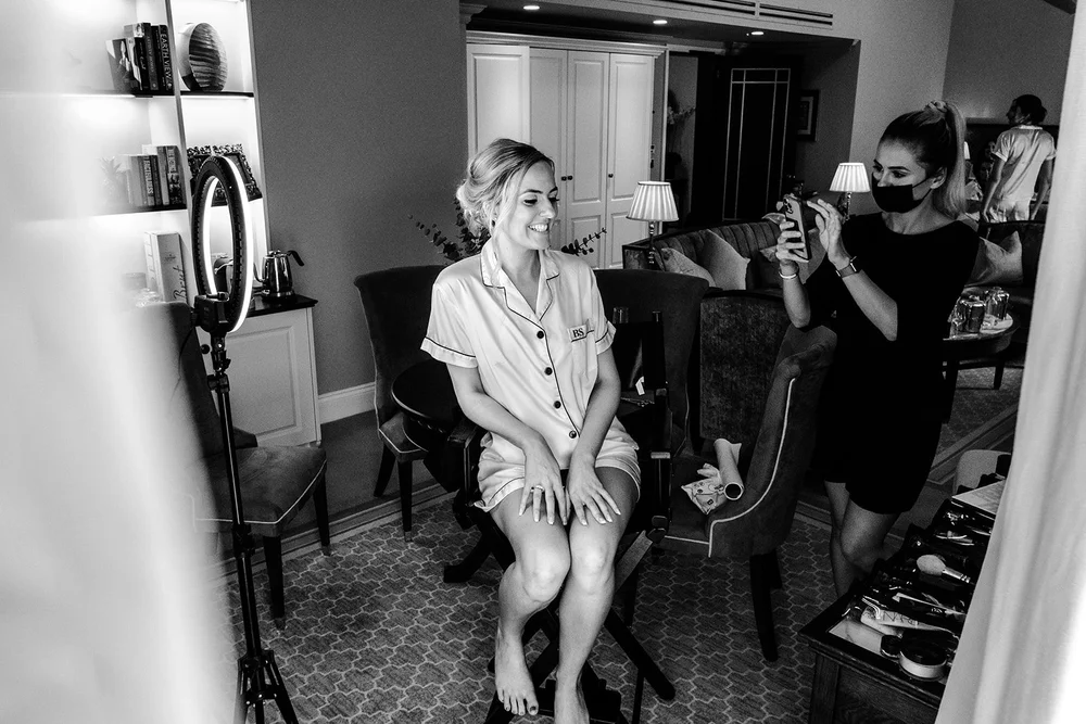 Black and white photograph of a bridesmaid in bridal pyjamas before the wedding