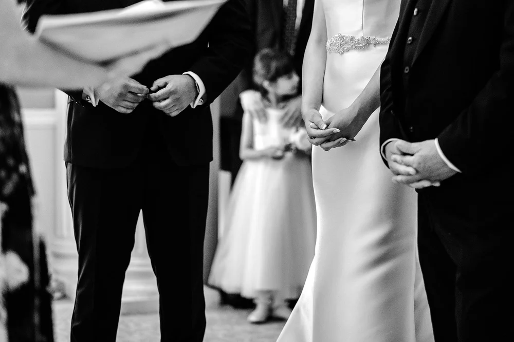 Black and white photograph of Bernie and Naesan exchanging rings