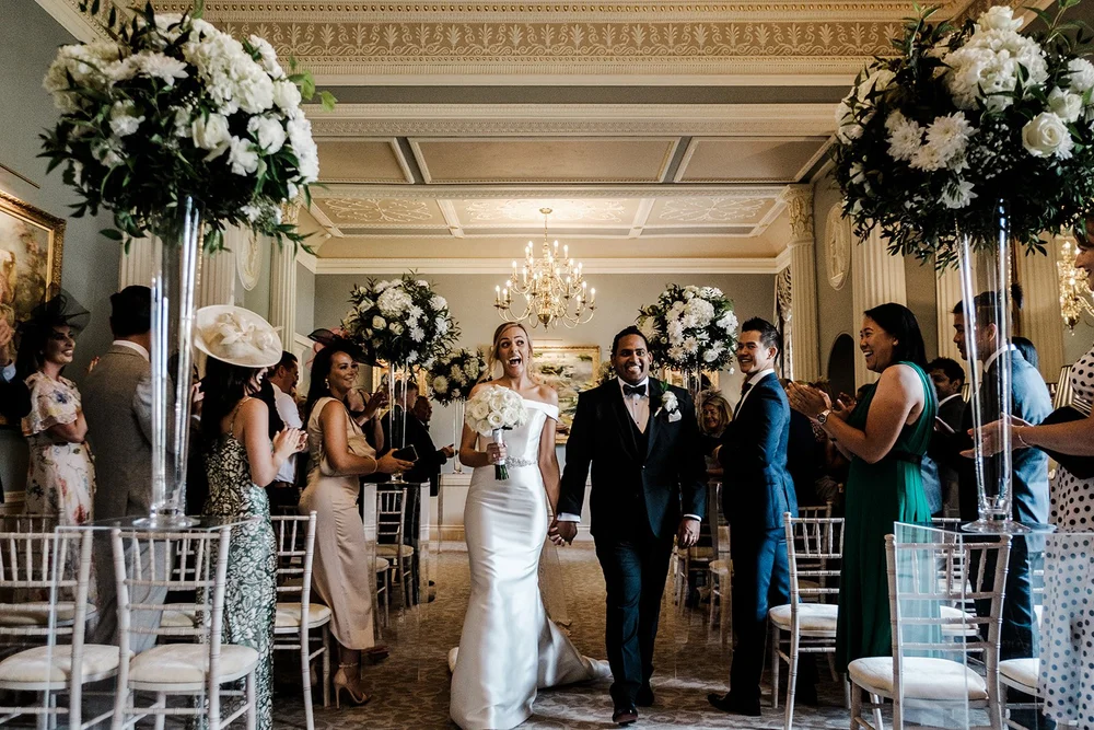 Bernie and Naesan walking through the dining room at Grantley Hall