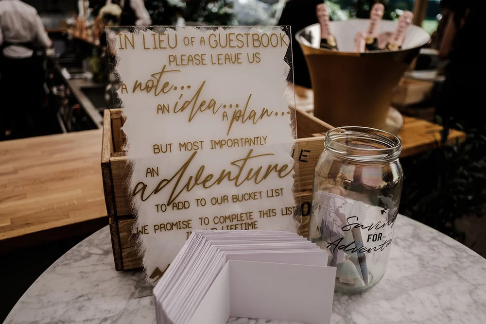 The guestbook table with a handwritten sign at the Grantley Hall reception