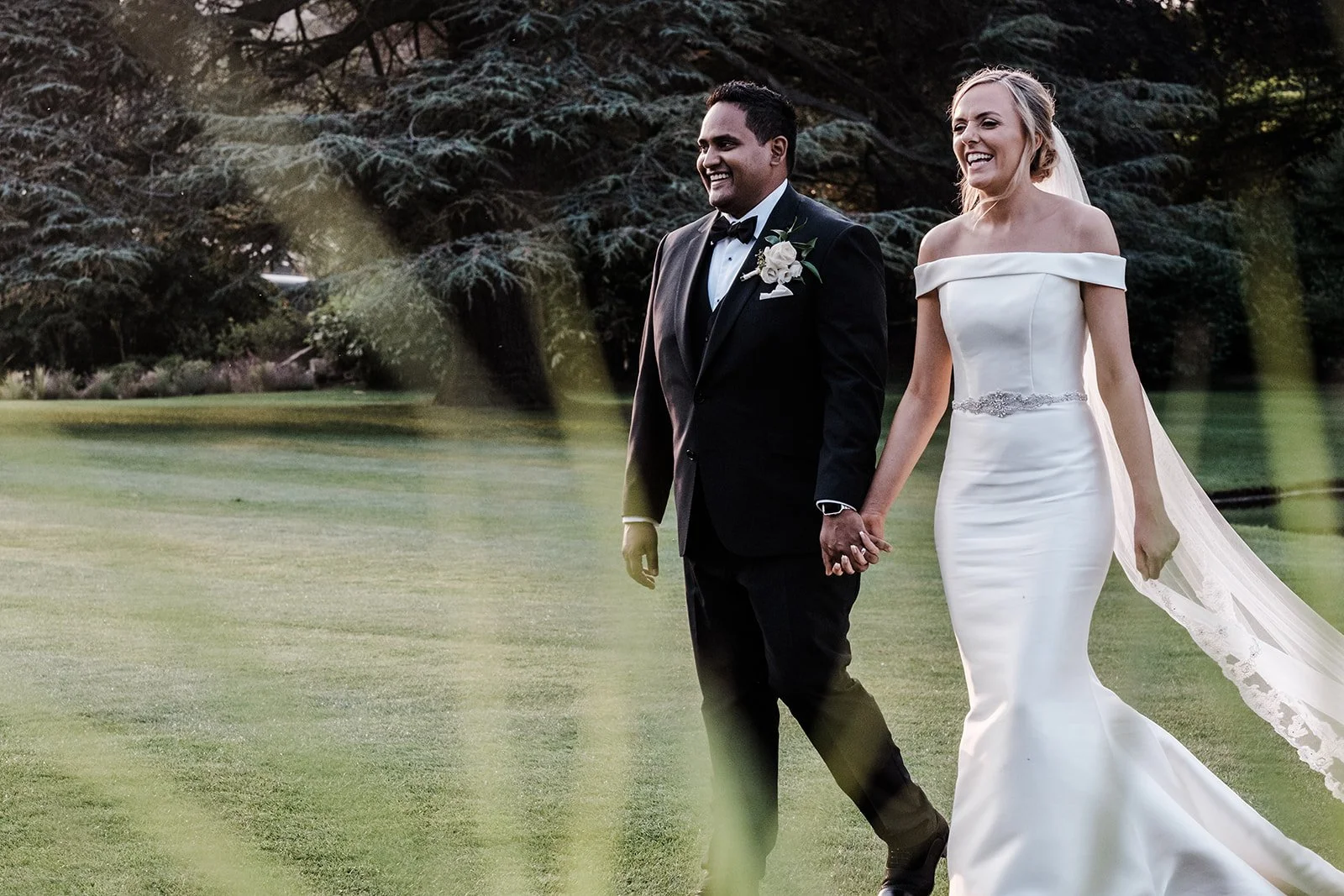 Bernie and Naesan walking across the lawn at Grantley Hall in the evening light