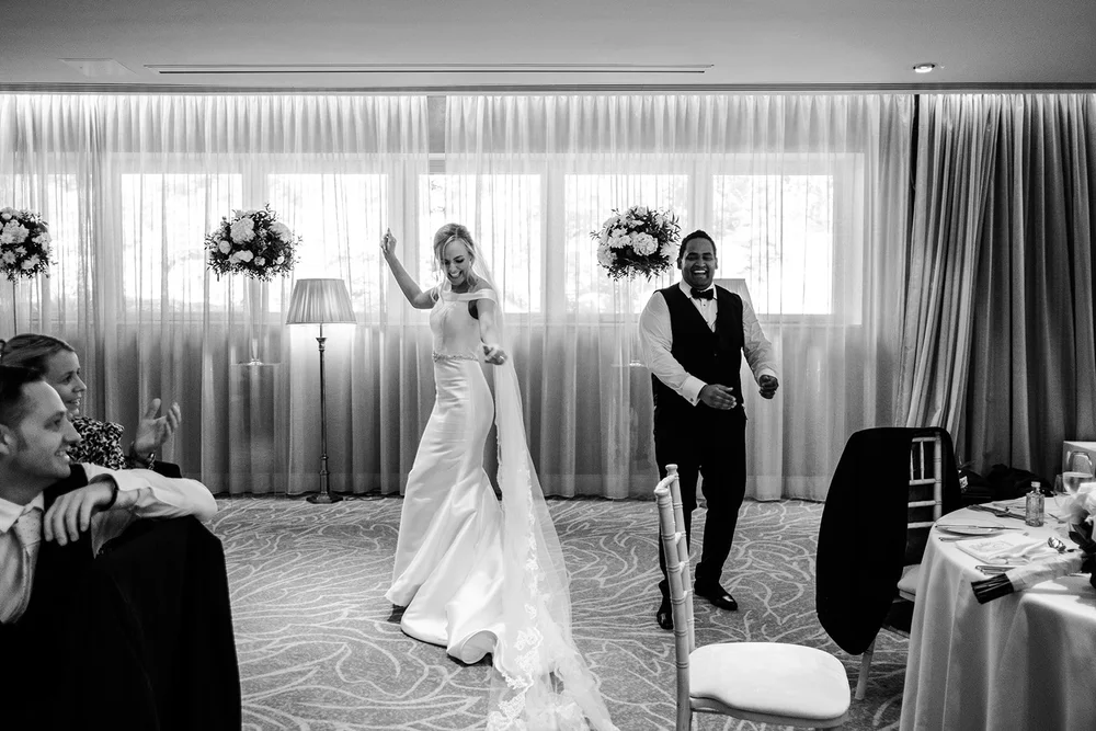 Black and white photograph of Bernie and Naesan entering the reception room