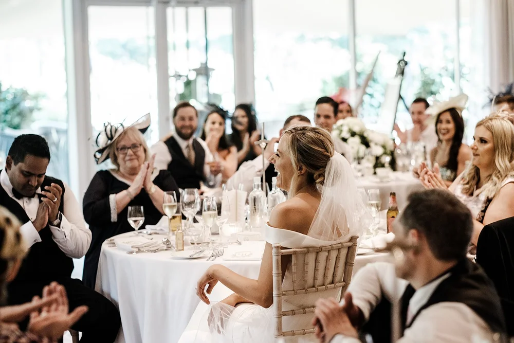 Guests applauding during the wedding speeches at Grantley Hall
