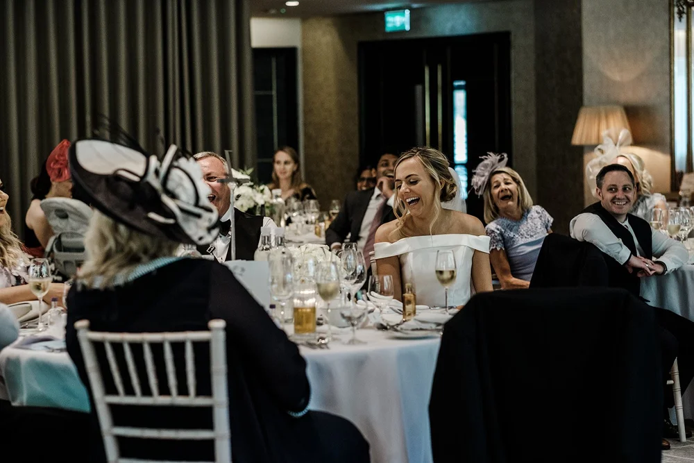 Guests in hats watching the speeches at Grantley Hall