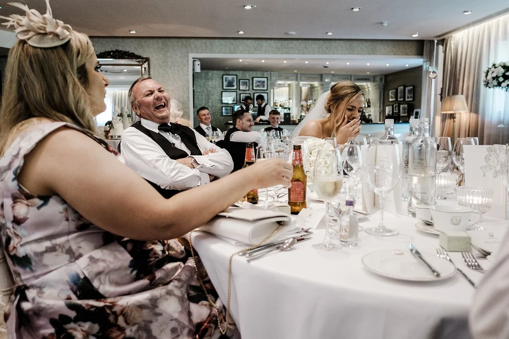 Guests laughing at the tables during the speeches at Grantley Hall