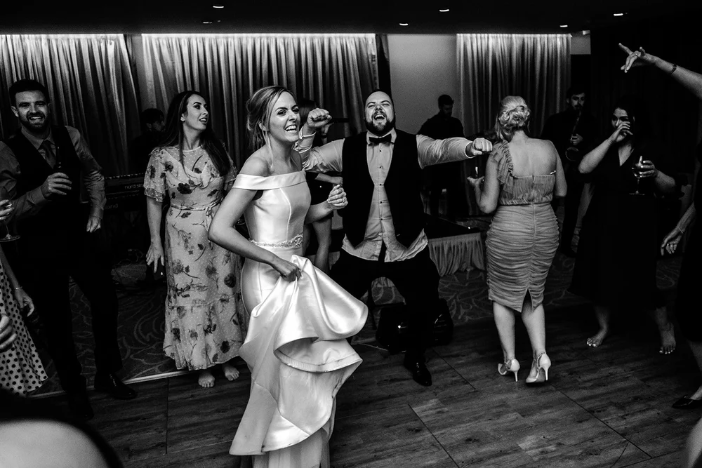 Black and white photograph of guests dancing in the evening at Grantley Hall