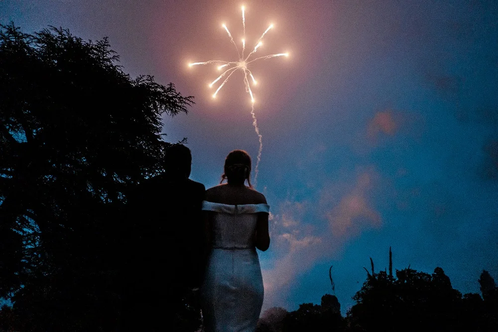 Bernie and Naesan silhouetted against the fireworks at Grantley Hall