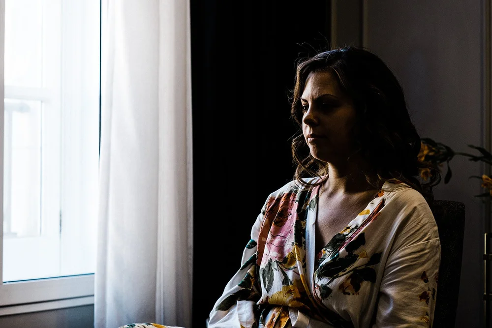 Anna in the window light during bridal preparations in London