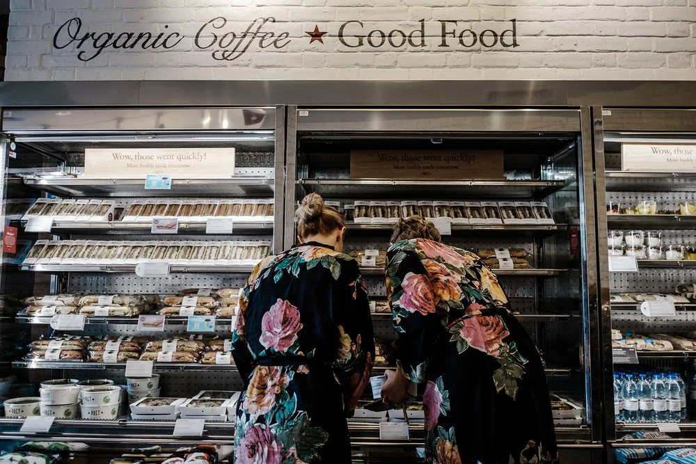 Bridesmaids buying provisions in a coffee shop on the morning of the wedding