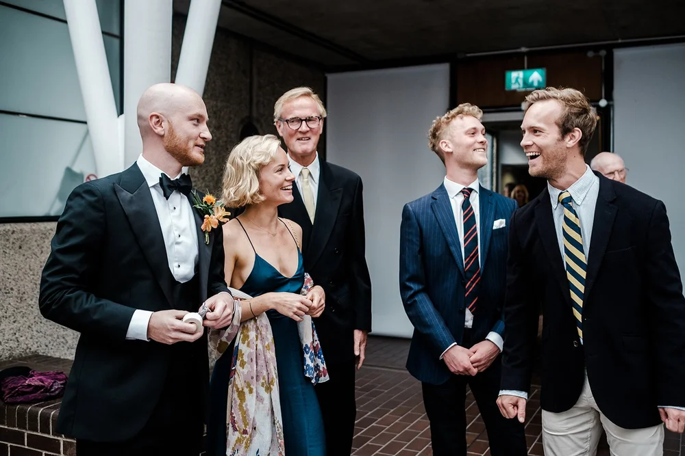 Jordan and his groomsmen greeting guests at the Barbican
