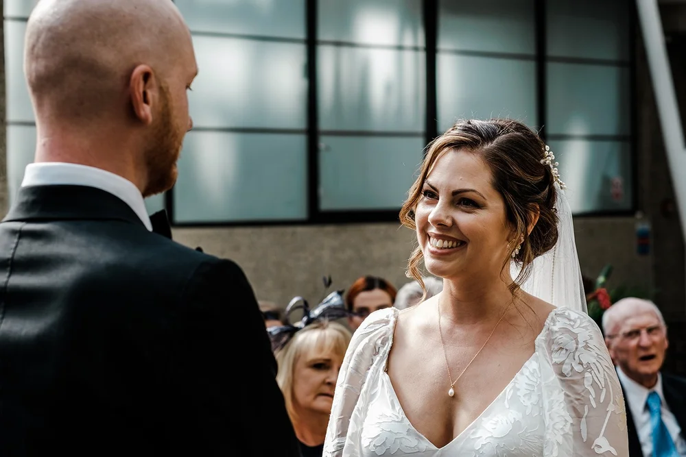 Jordan and Anna facing each other during their ceremony at the Barbican