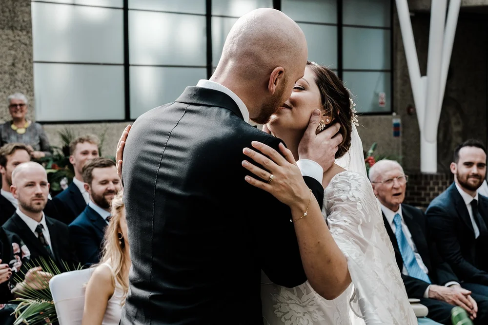 Jordan and Anna kissing after their vows in the Barbican Conservatory