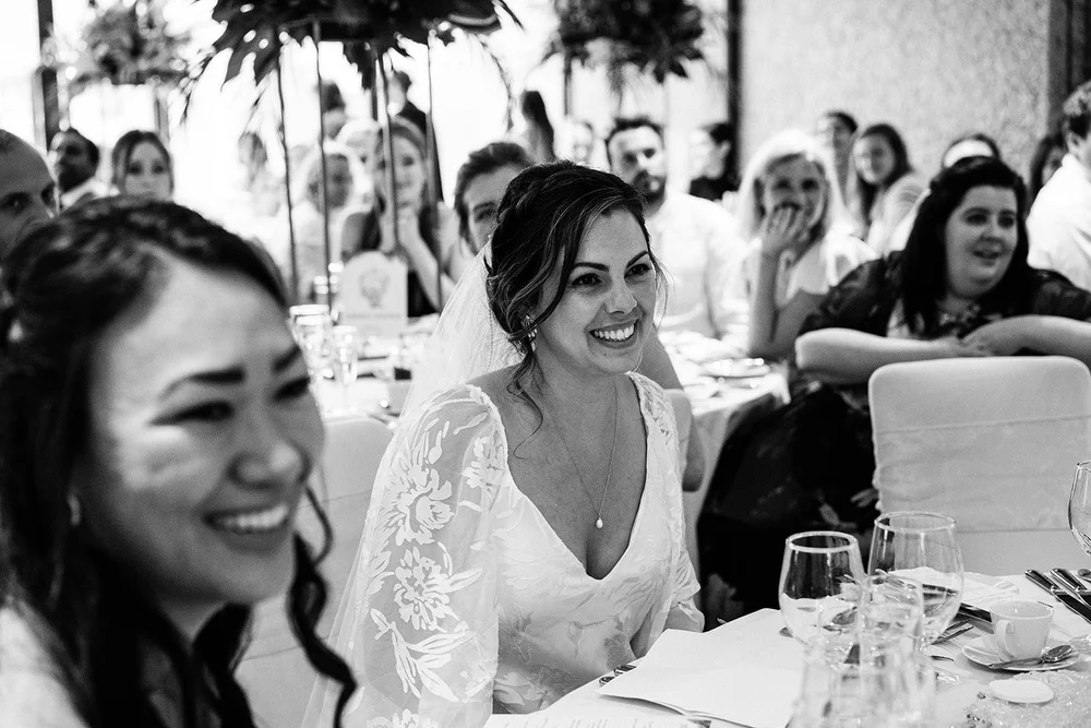 A guest laughing at the table during the wedding breakfast