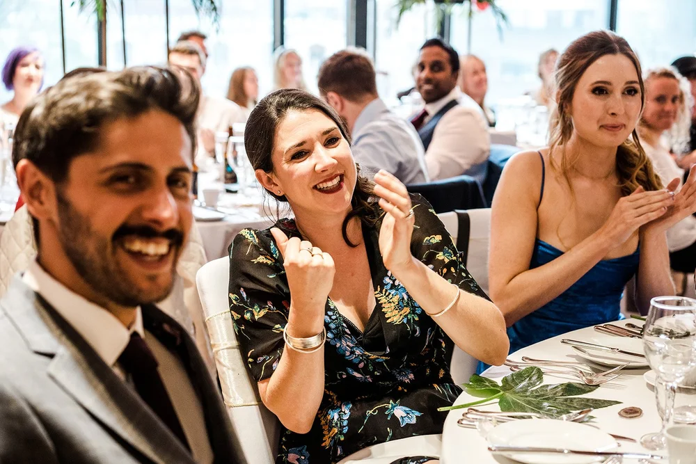 Guests applauding at the table during the speeches