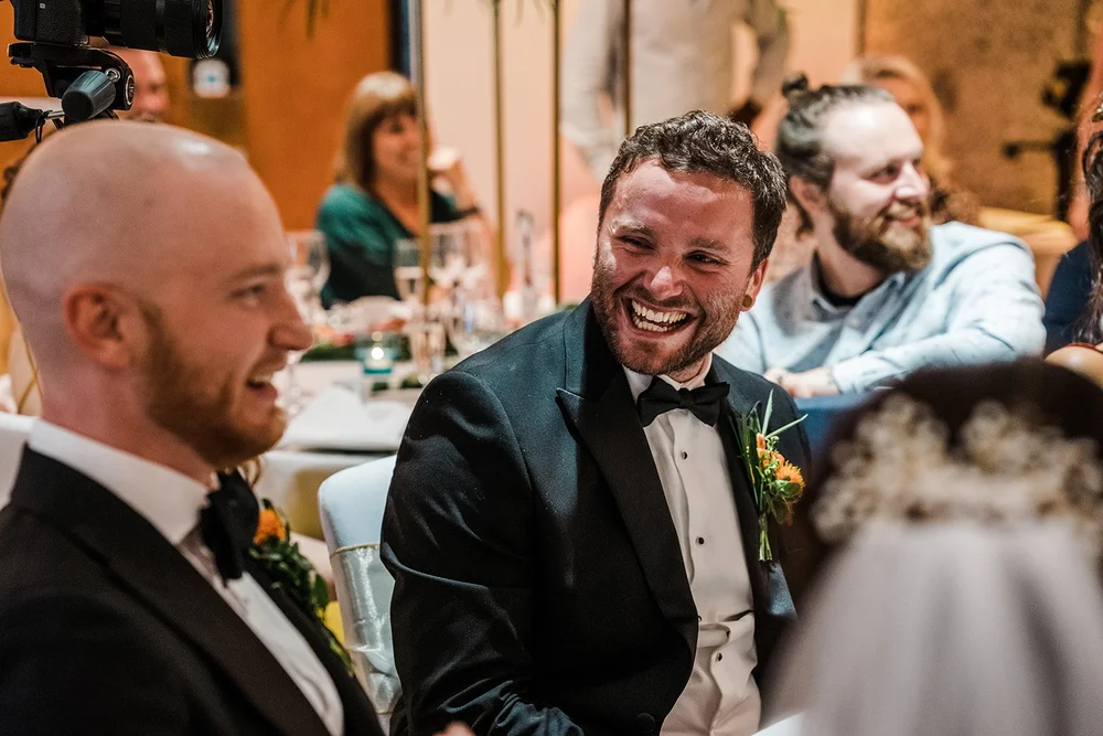 Jordan laughing with a guest during dinner