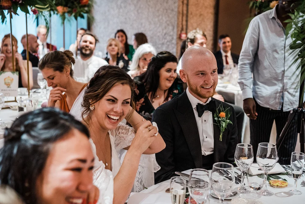 Jordan and Anna laughing with guests at the table
