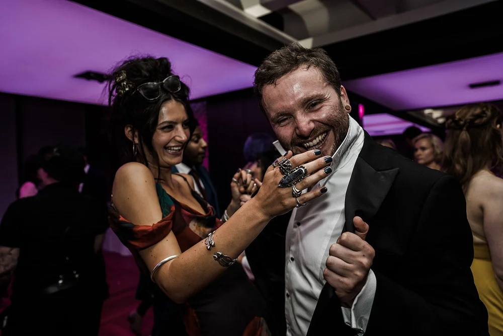 Guests dancing under coloured lights at the the Barbican reception