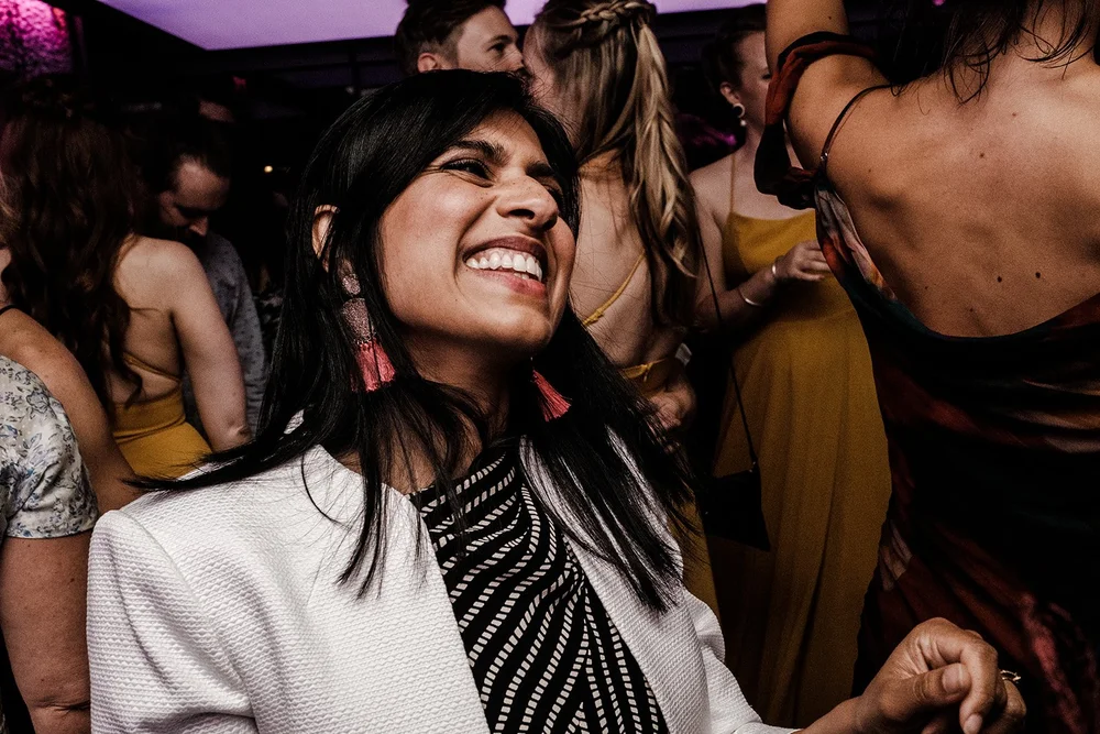 A guest laughing on the dance floor in the evening