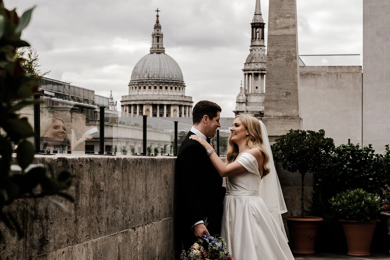 Jen and Rich on the terrace at The Ned with St Paul&rsquo;s Cathedral behind them
