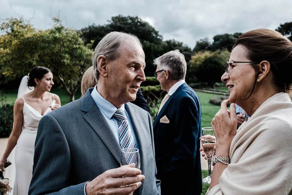 Guests with drinks in the grounds at Clevedon Hall, North Somerset