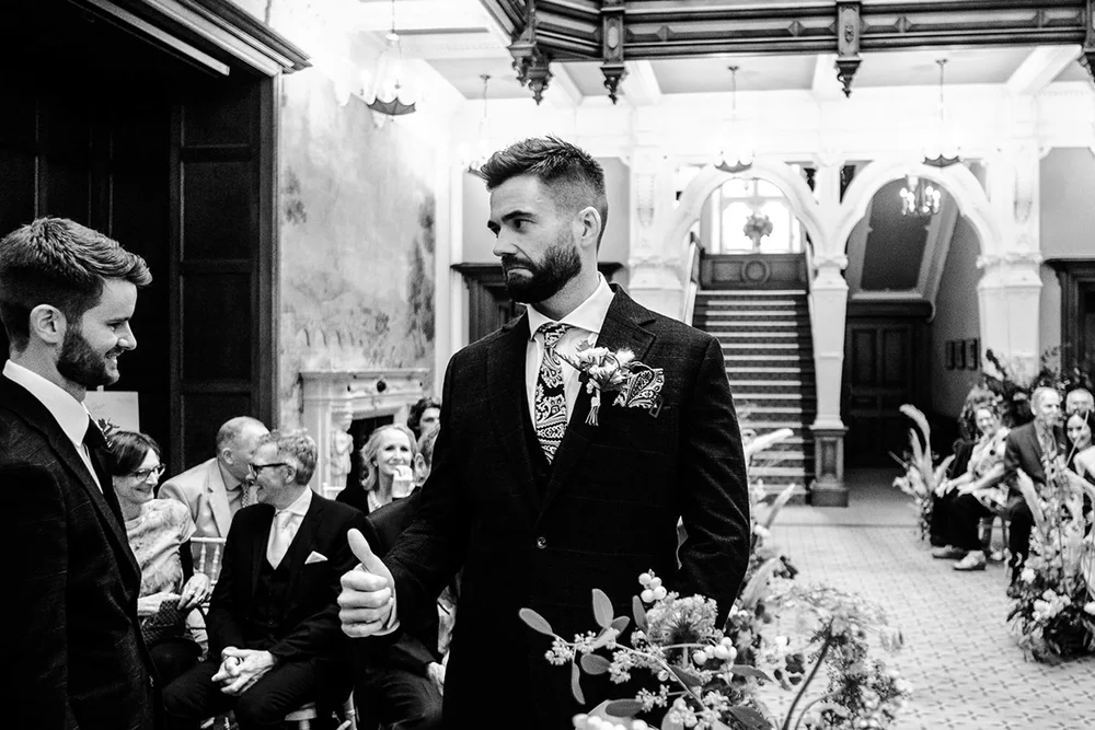Josh waiting at the front with his best man before the ceremony at Clevedon Hall
