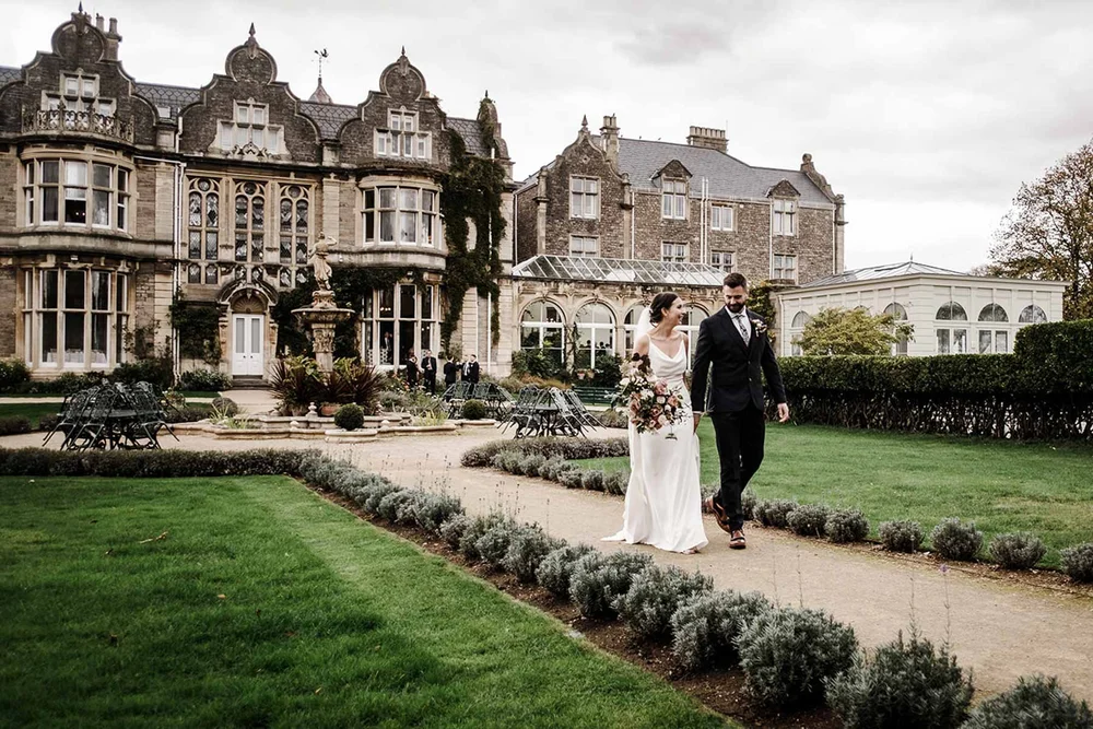 Sarah and Josh in the grounds at Clevedon Hall, the Victorian mansion behind them, North Somerset