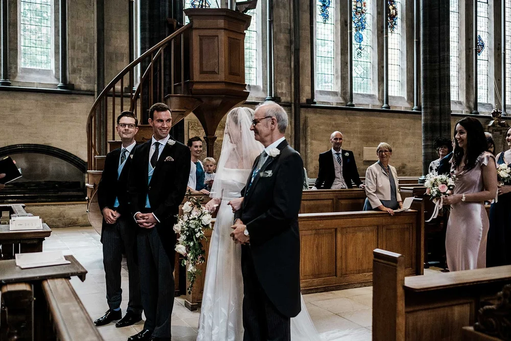 Ollie and Gina at the altar during their wedding ceremony at Temple Church