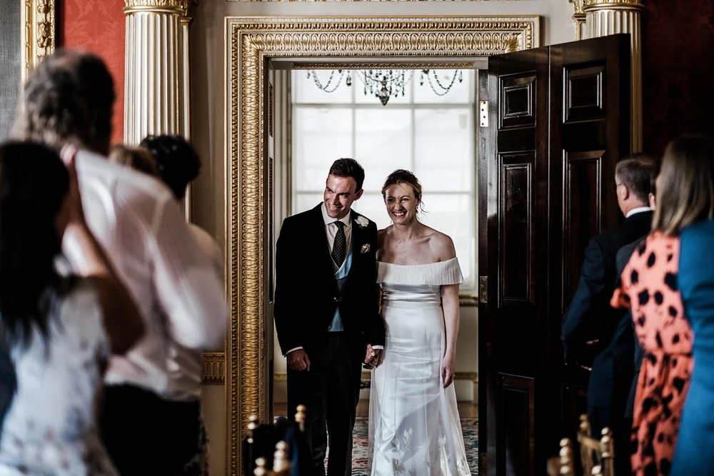 Gina and Ollie framed in the doorway at Spencer House in St James&rsquo;s