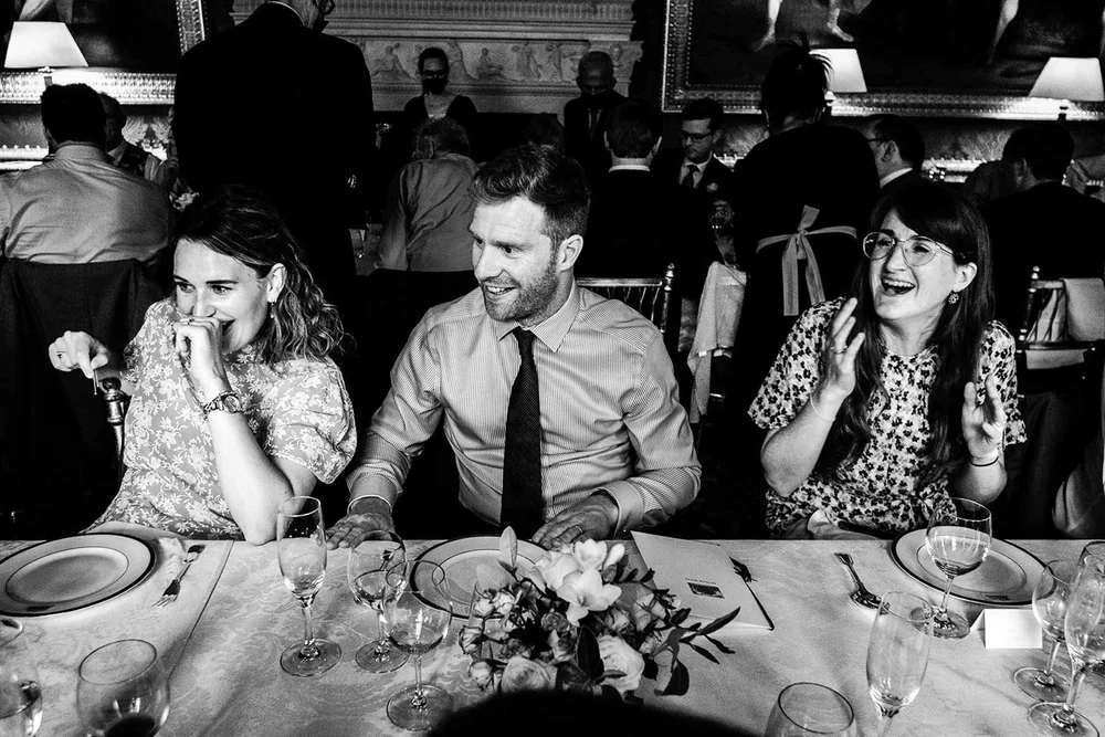 Black and white photograph of guests reacting to the speeches at Spencer House