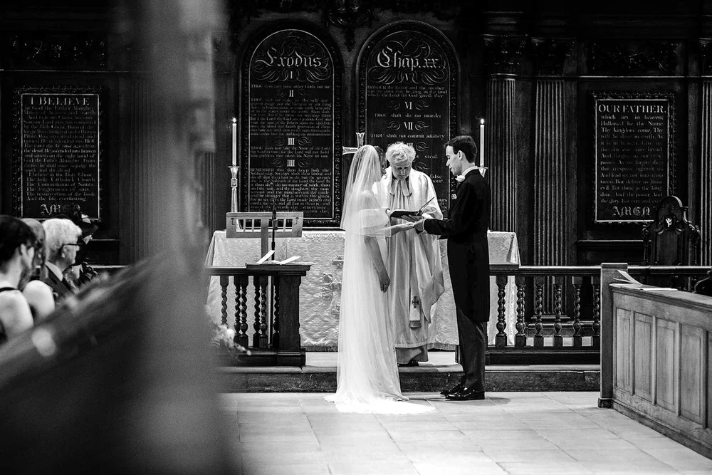 Black and white photograph of Gina and Ollie during the ceremony at Temple Church