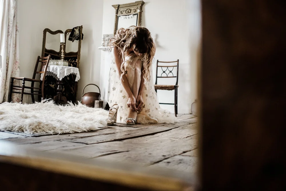 Jess in her sequinned wedding dress in the window light