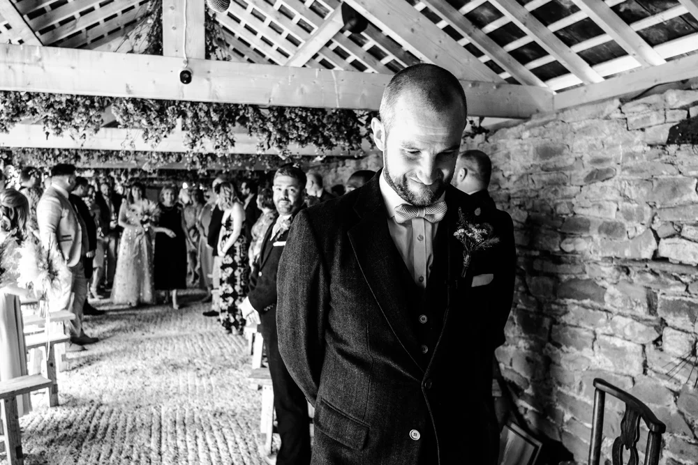 Black and white photograph of Tom waiting before the ceremony at Lyde Court