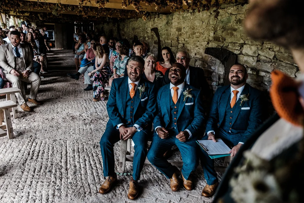 Guests seated in the stone barn for the humanist ceremony at Lyde Court