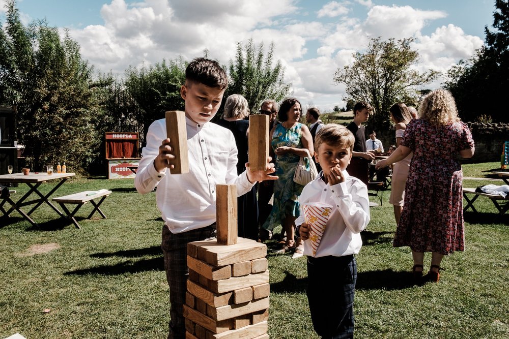 Guests playing giant Jenga in the grounds at Lyde Court