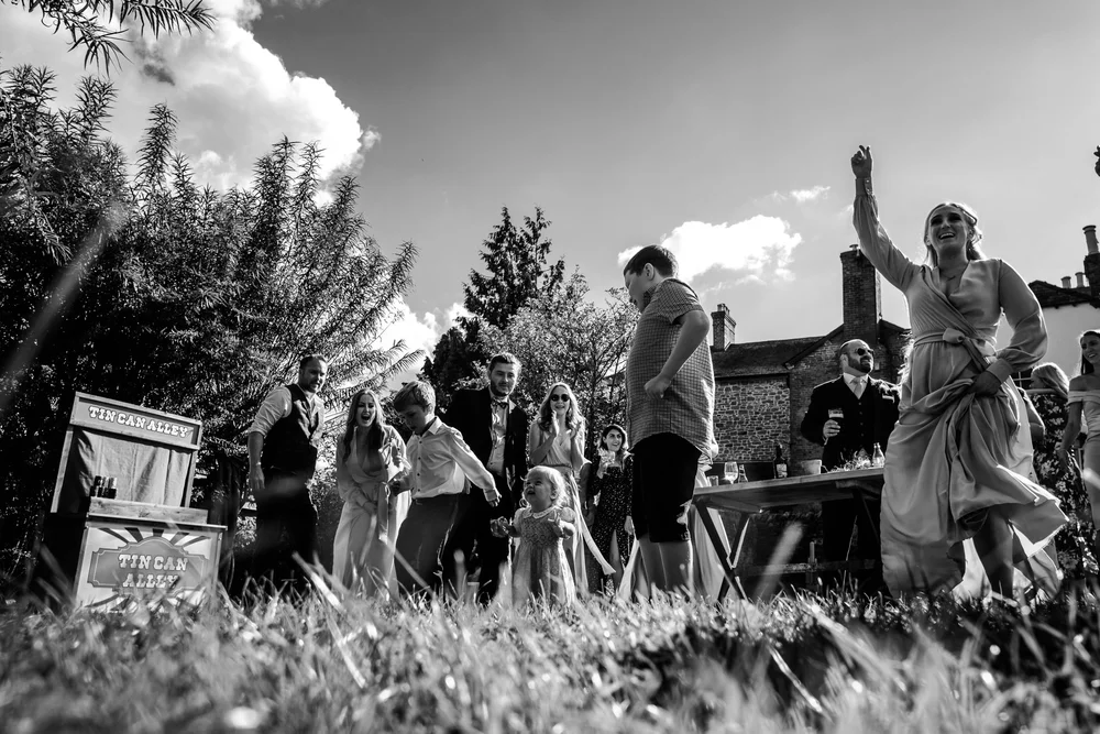 Black and white photograph of guests watching a performance in the field